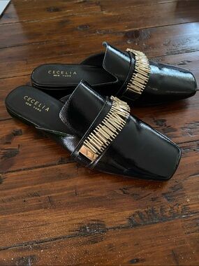 CECELIA NEW YORK Black Patent Slip-On Mules with Gold Fringe Detail